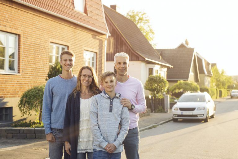 Family posing on street